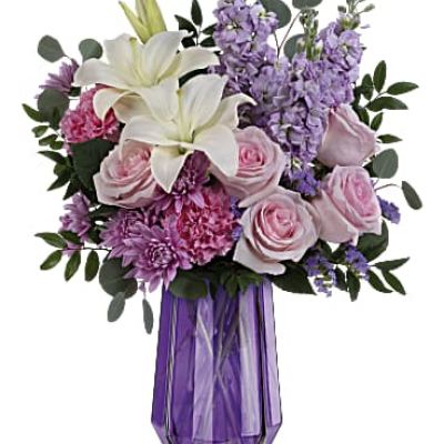 Wish her a Mother's Day of wonder and whimsy with Teleflora's Lavender Whimsy Bouquet featuring a breathtaking rose and lily bouquet in this stunning geometric glass vase.