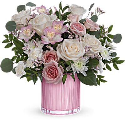 Teleflora's Posh Pink Bouquet has creamy roses and delicate pink blooms which are the perfect Mother's Day surprise, especially when they're arranged in this sculpted, pearlescent glass vase.