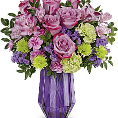 Like a fine, faceted gemstone, Teleflora's Geometric Rose Bouquet features a gorgeous glass vase that sparkles beneath a bouquet of lush lavender roses.